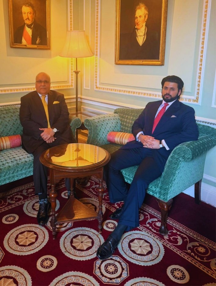 Xyra Group principals in private session beneath aristocratic portraits