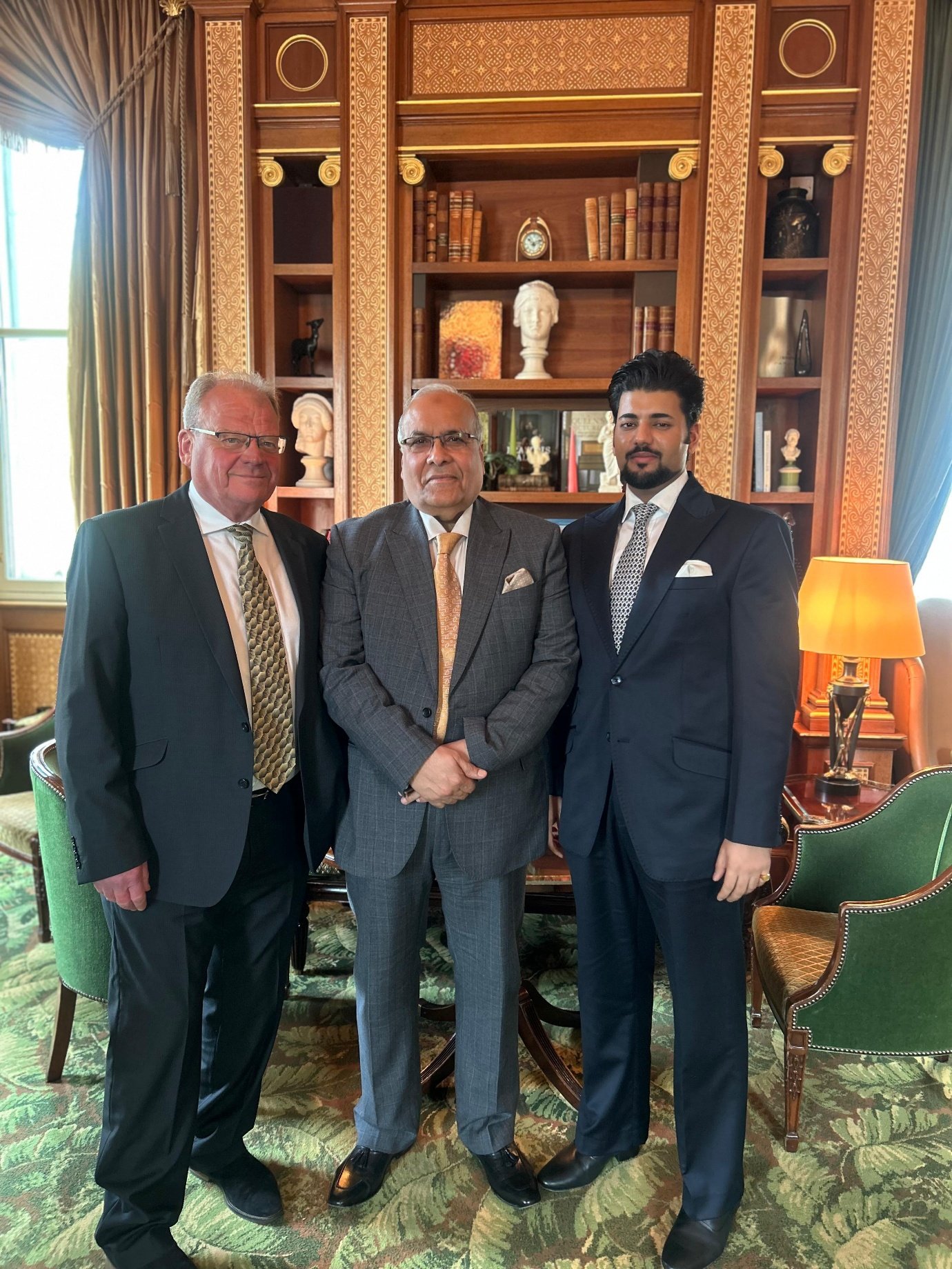 Xyra Group principals seated in counsel beneath aristocratic portraits